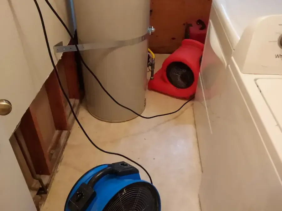 Air movers beside a water heater and open wall framing